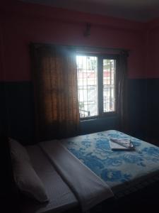 A bed or beds in a room at Krishna Inn