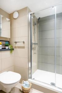 a bathroom with a shower and a toilet at Inspiring Spaces at Zinc Works in Bristol