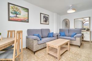 a living room with two couches and a table at Cazabonnet in Frigiliana