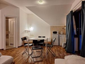 a kitchen and dining room with a table and chairs at 2-Rent Group Hostel Rooms AUB162 in Munich