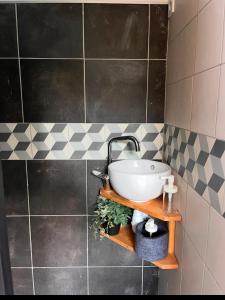 La salle de bains est pourvue d'un lavabo et d'un mur carrelé. dans l'établissement Atelier, à Saint-Mandrier-sur-Mer