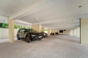 a garage with two cars parked in it at Treebo Pratham Inn, Manipal in Udupi
