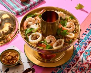a bowl of food with shrimp and rice on a table at Sindhorn Midtown Hotel Bangkok, Vignette Collection by IHG in Bangkok