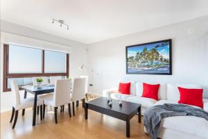 a living room with a white couch and a table at Villa Margarita in Vélez-Málaga