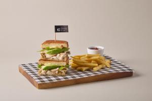 a sandwich and french fries and a cup of ketchup at Days Inn by Wyndham Patong Beach in Patong Beach