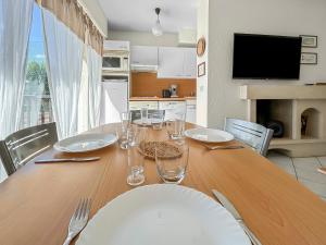 a dining room table with wine glasses on it at La Pause Cabourgeaise in Cabourg