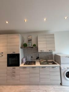 a kitchen with a sink and a stove top oven at La casa del cuore in Montefiascone