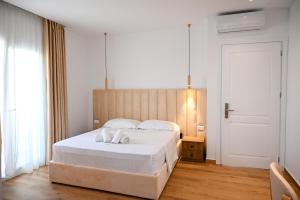 Postel nebo postele na pokoji v ubytování Hotel Vila AARON