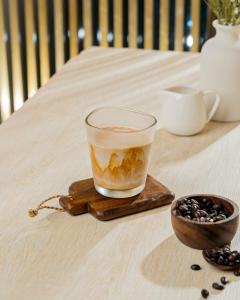 a cup of coffee and a bowl of coffee beans at Sindhorn Midtown Hotel Bangkok, Vignette Collection by IHG in Bangkok