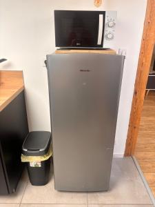 una nevera con ordenador portátil encima en Wood loft by Mulhouse, en Mulhouse