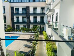 an external view of a building with a swimming pool at Cozy Abode by Embassy Gardens in Cantonments