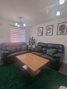 a living room with a couch and a coffee table at Urban Retreat in Newcastle- Pet friendly- Garden in Newcastle upon Tyne