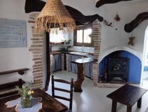 a living room with a table and a fireplace at Les Olles in Regués