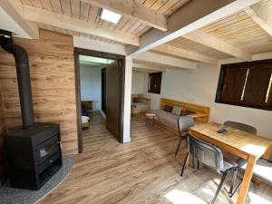 a living room with a fireplace and a stove at Stanetestruzhes in Prizren