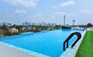 a large swimming pool on the roof of a building at Starlit Suites Newtown Kolkata in kolkata