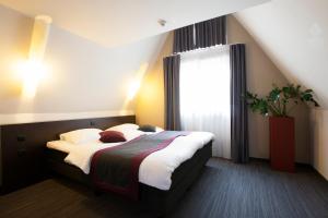 Voodi või voodid majutusasutuse Hotel Vé toas