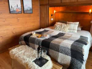 a bedroom with a bed with a blanket and a table at Verbier 2 bedrooms apartment- Scenic view - 6 Pax in Verbier