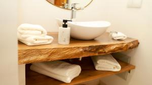a bathroom sink on a wooden shelf with towels at Riad Reflet D'orient Marrakech in Marrakesh +50 photos