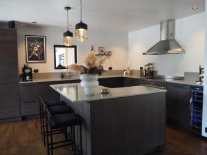 a kitchen with a large island with a vase on it at Social villa near the sea! in Torslanda +19 photos