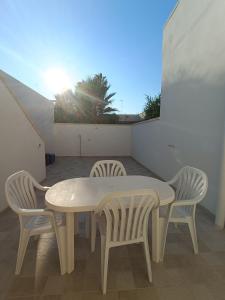 a table and chairs on a balcony with the sun at Le 2 Volte in Carmiano