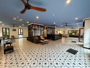 a large living room with a ceiling fan and cages at Thala Hotel Sorrento in Phú Quốc