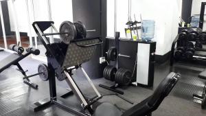 a room with a gym with a chair and weights at Purplehaze Place in Nairobi