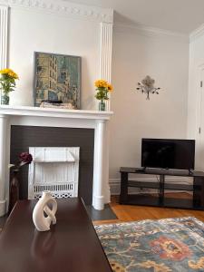 a living room with a table and a fireplace at Stunning 3BR-Private Entrance-Renovated-Near City in Pittsburgh
