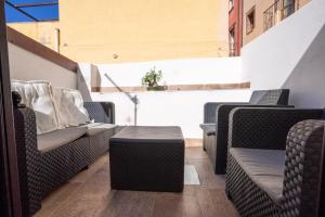 a group of chairs and a table in a room at Sardinian Gallery Domus Historic Rooms & Apartments in Bosa