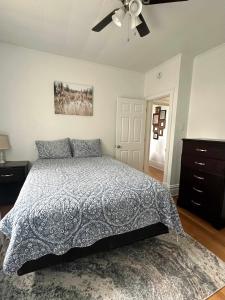 a bedroom with a bed and a ceiling fan at Stunning 3BR-Private Entrance-Renovated-Near City in Pittsburgh