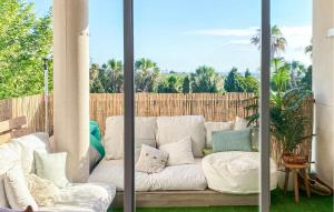 a white couch with pillows on a patio at 2 Bedroom Gorgeous Apartment In Sagunto in Sagunto