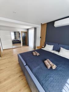 a bedroom with a blue bed with two towels on it at Villa Milamar in Banjol
