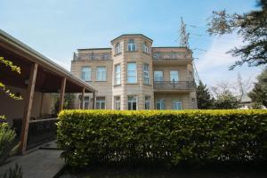 a building with a hedge in front of a building at Villa near Nizami Street in Baku