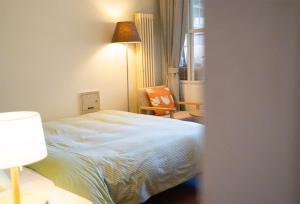 Un dormitorio con una cama y una silla y una ventana. en Xinxinjia, en Beijing