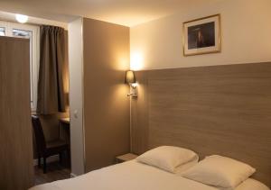 a hotel room with a bed and a desk at Paris Rooms & Dreams Hotel in Paris