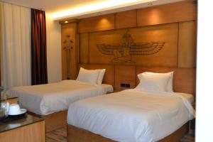 Voodi või voodid majutusasutuse Neom Pyramids Valley Boutique hotel toas