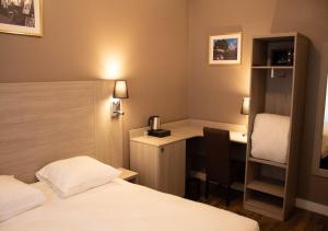 a hotel room with two beds and a desk and a desk at Paris Rooms & Dreams Hotel in Paris +16 photos