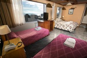 Hotel Aspen Ski tesisinde bir odada yatak veya yataklar