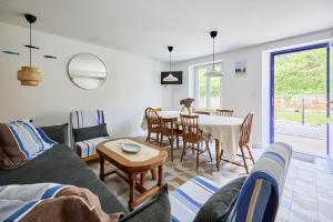 a living room with a couch and a table at La Maison Valnotte - Proche du port de Carteret in Barneville-Carteret +6 photos