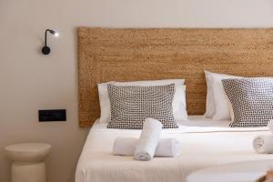 a bedroom with two beds with white sheets and pillows at Noe Rooms In Center Of Tinos in Tinos