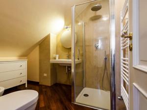 a bathroom with a shower and a toilet and a sink at Porticciolo sea view in Aci Castello