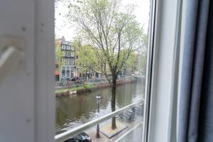 a view of a river from a window at The Crown Hotel in Amsterdam