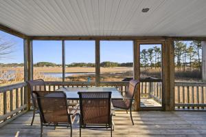 a patio with a table and chairs on a deck at Island Retreat in Birch Town