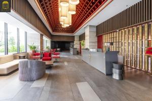 a lobby of a building with tables and chairs at Apec By Vu Hai Phan Thiet in Mui Ne