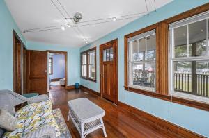 a living room with a couch and windows at Starbright Cottage in Chincoteague