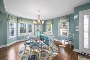 a dining room with a table and chairs at Barefoot Breeze in Deep Hole +27 photos