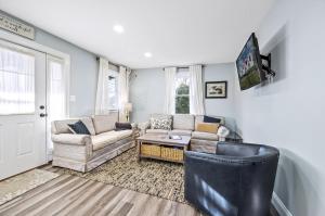a living room with a couch and a table at Hudson House in Chincoteague