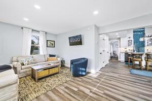 a living room with a couch and a table at Hudson House in Chincoteague