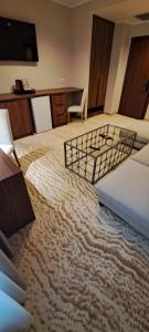 a room with a carpeted floor with two beds at Embassy Romana in Bucharest