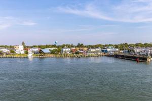a large body of water with houses and a dock at At The Waters Edge in Chincoteague