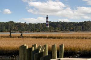 a lighthouse in the middle of a field with a fence at Wonderview 208 in Birch Town